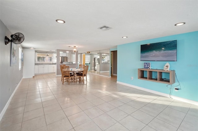 unfurnished dining area with light tile patterned flooring