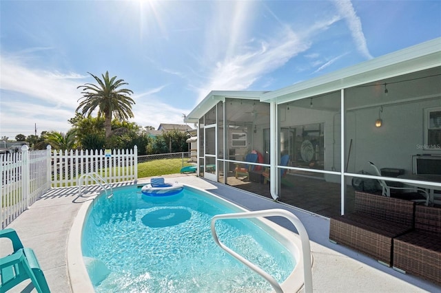 view of pool featuring a patio area and a sunroom