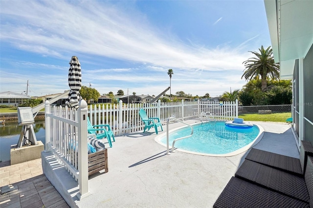 view of swimming pool featuring a water view and a patio area