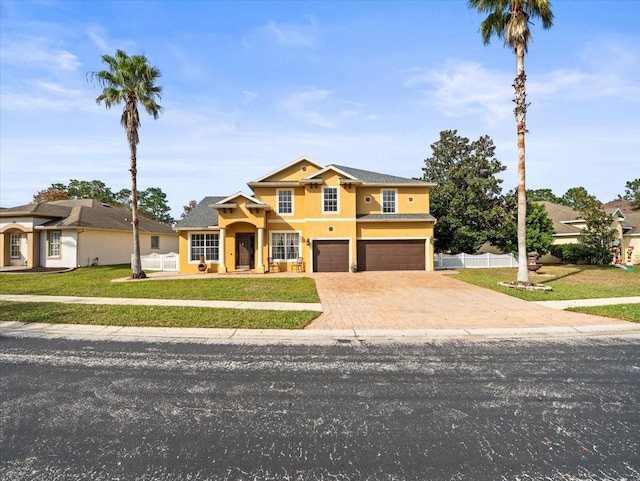 view of front of home with a garage and a front lawn