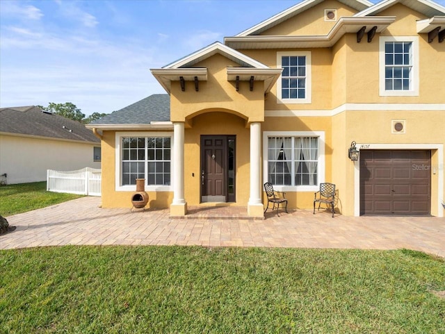 exterior space featuring a garage and a front lawn