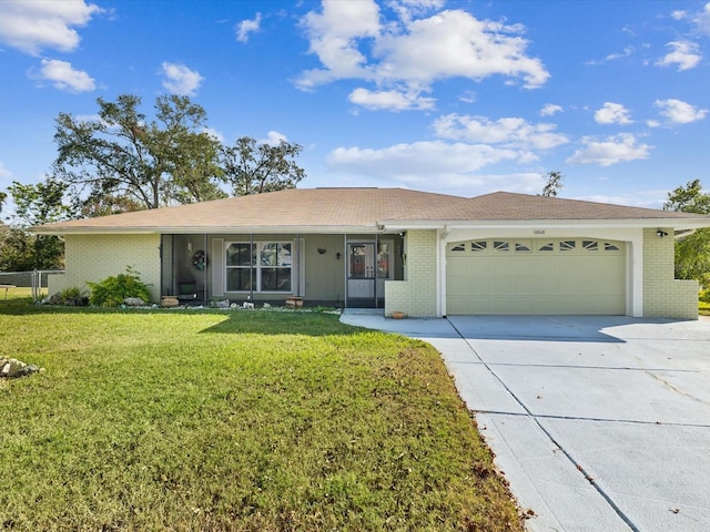 ranch-style house with a garage and a front lawn