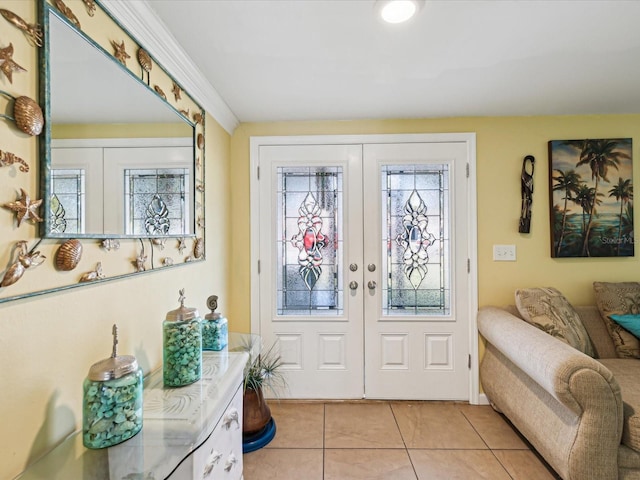 tiled foyer entrance with crown molding and french doors