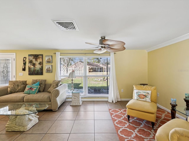 tiled living room featuring ceiling fan and crown molding