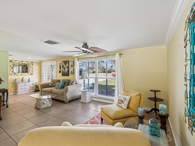 living room with ceiling fan, ornamental molding, and light tile patterned flooring