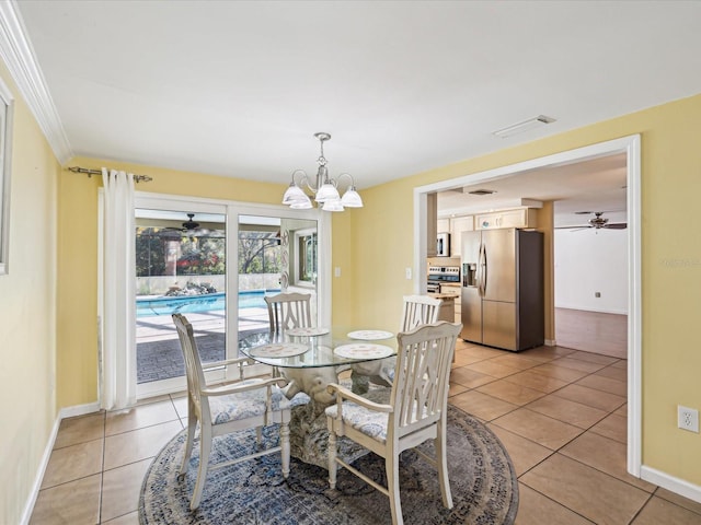 dining area with ceiling fan with notable chandelier, ornamental molding, and light tile patterned flooring