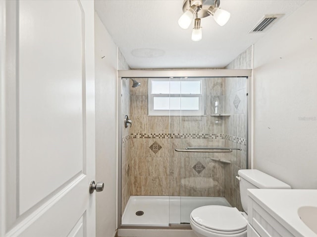 bathroom featuring vanity, toilet, and an enclosed shower