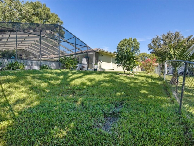 view of yard with glass enclosure