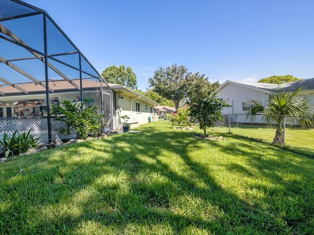 view of yard featuring glass enclosure