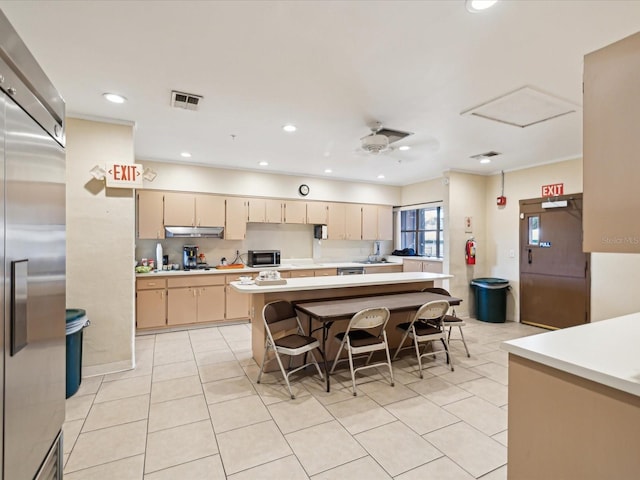 kitchen with ceiling fan, high end fridge, light tile patterned floors, and cream cabinetry