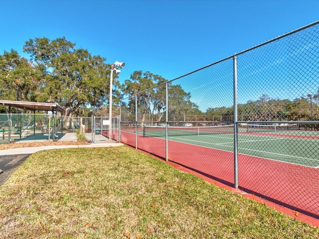 view of sport court featuring a yard