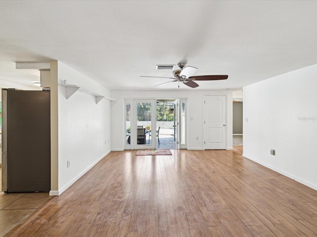 unfurnished living room with light hardwood / wood-style flooring and ceiling fan