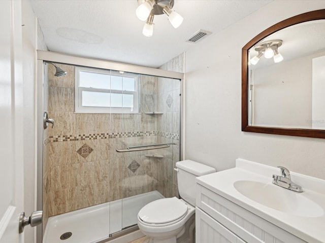 bathroom featuring vanity, an enclosed shower, and toilet