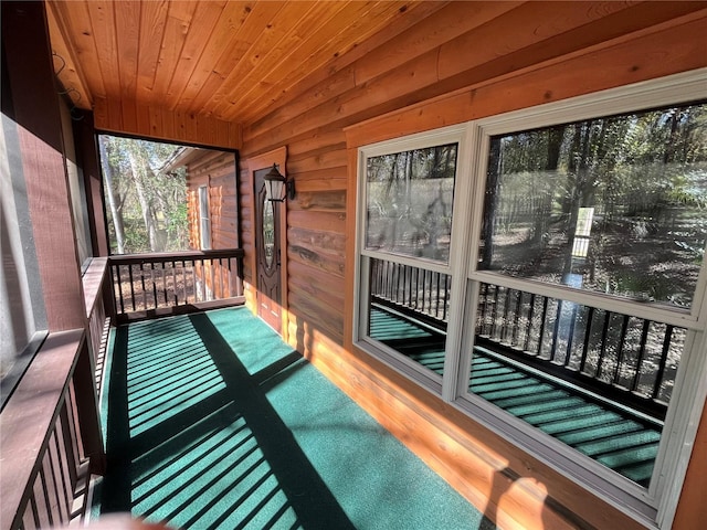 unfurnished sunroom featuring wooden ceiling