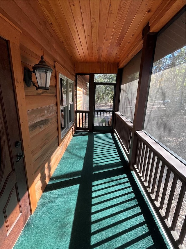 sunroom featuring wood ceiling