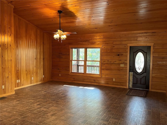 entrance foyer with wood walls, ceiling fan, and wood ceiling