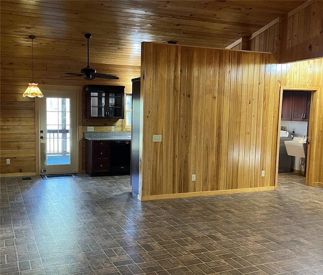 unfurnished living room with ceiling fan, wooden ceiling, and wood walls