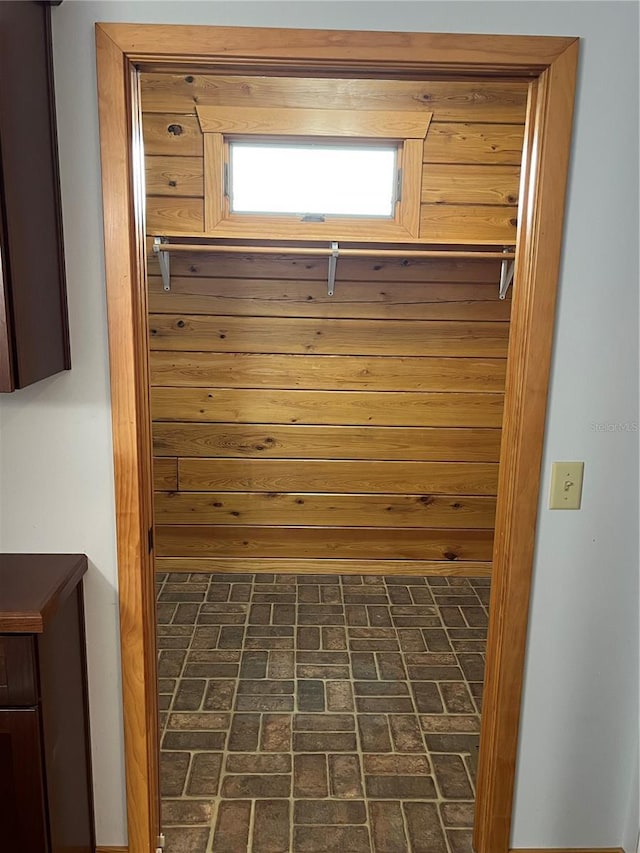 mudroom with wooden walls