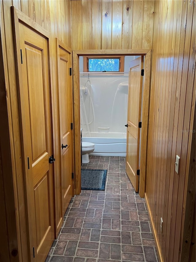 hallway with wood walls