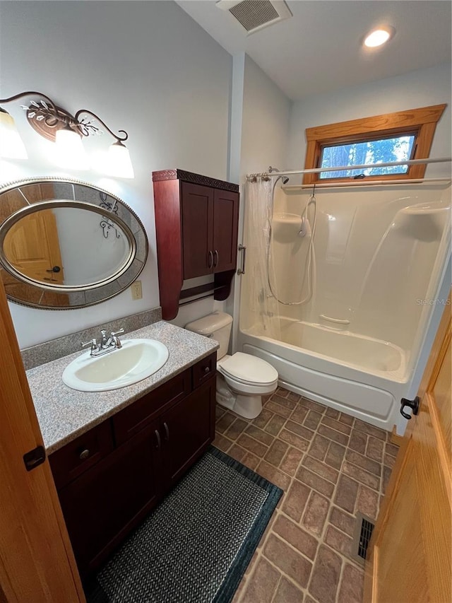 full bathroom with toilet, vanity, and washtub / shower combination