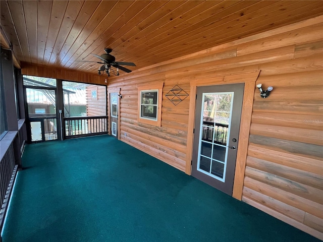 unfurnished sunroom featuring ceiling fan and wood ceiling