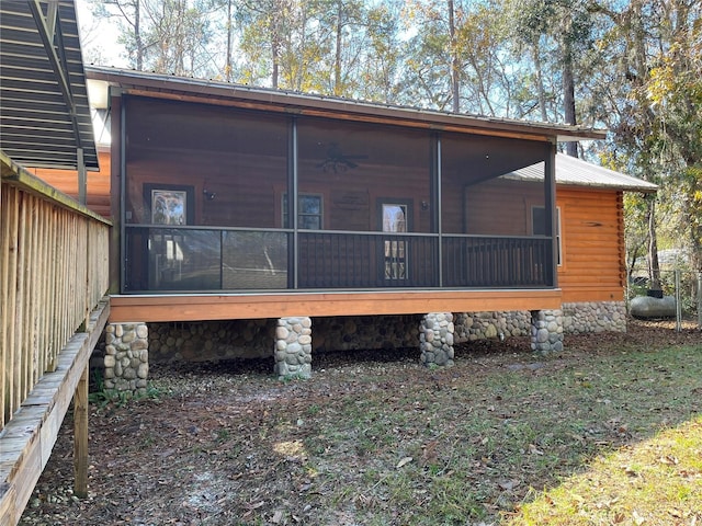 rear view of property featuring a sunroom