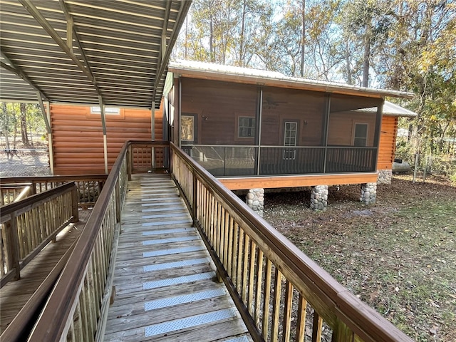 wooden deck with a sunroom