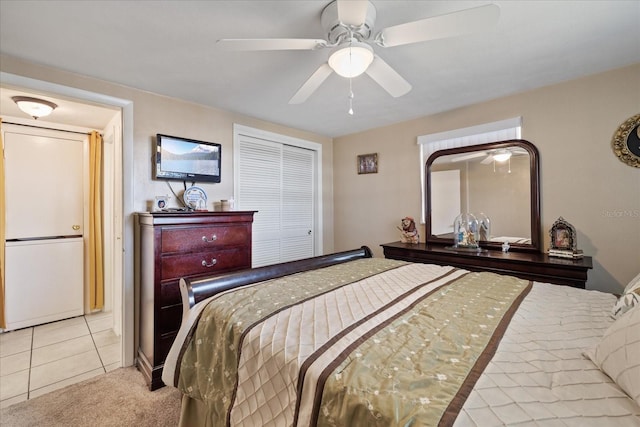 bedroom with ceiling fan and light tile patterned flooring