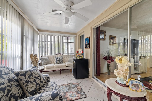 living room with ceiling fan and light tile patterned flooring