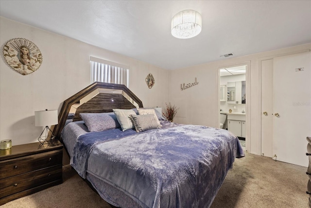 carpeted bedroom featuring connected bathroom