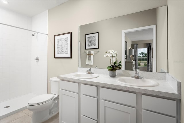 bathroom featuring tile patterned flooring, vanity, toilet, and walk in shower