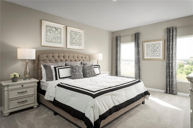 carpeted bedroom featuring multiple windows