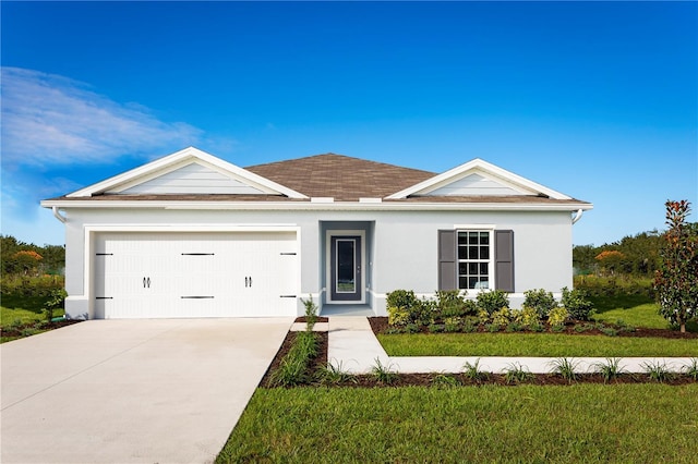 view of front of home featuring a front yard and a garage