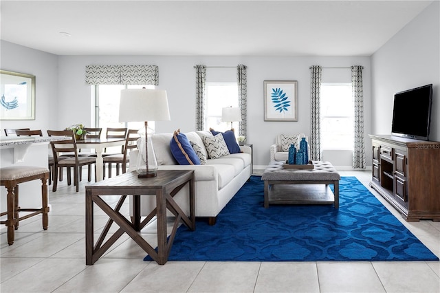 living room featuring a wealth of natural light and light tile patterned flooring