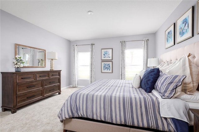 carpeted bedroom featuring multiple windows