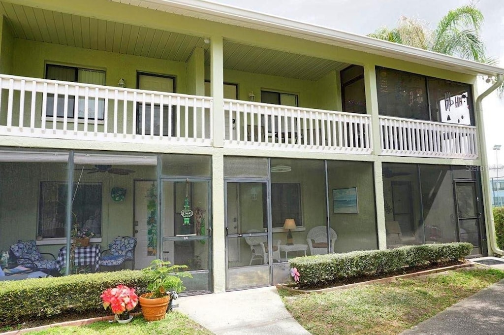 back of property featuring a balcony