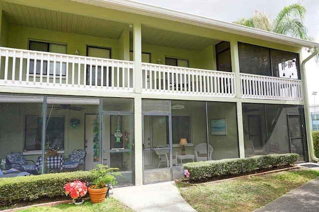 back of property featuring a balcony