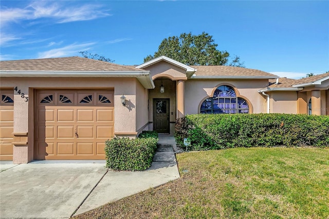 view of front of home with a front lawn and a garage