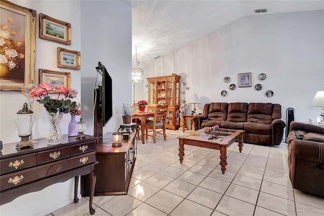 living room featuring light tile patterned floors, vaulted ceiling, and a notable chandelier