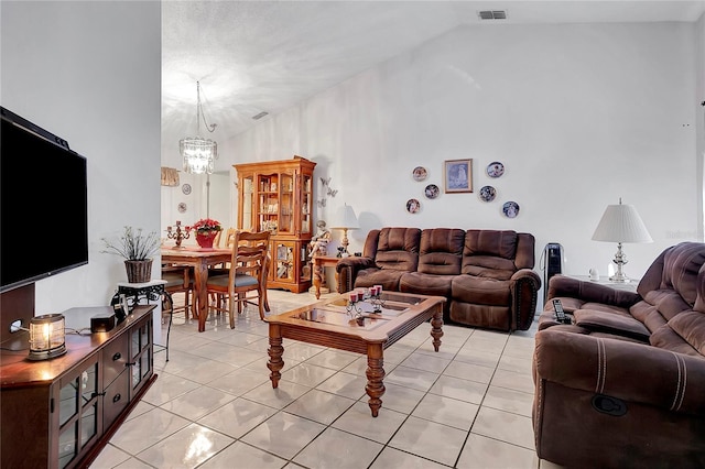 living room with an inviting chandelier, vaulted ceiling, and light tile patterned flooring