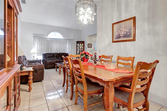 dining area featuring a notable chandelier and light tile patterned flooring