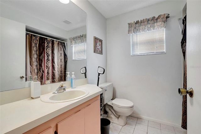 bathroom featuring tile patterned flooring, vanity, and toilet