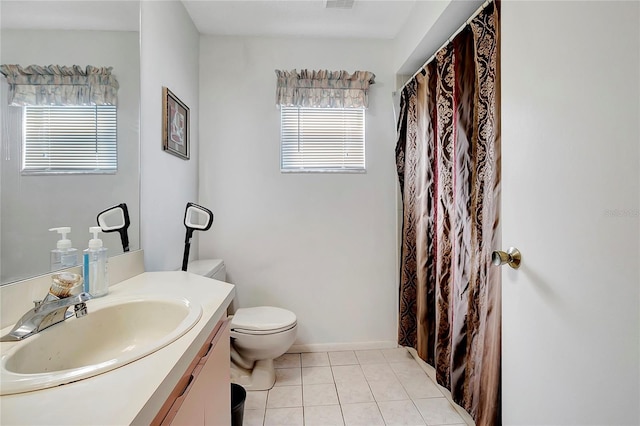 bathroom featuring tile patterned flooring, vanity, and toilet