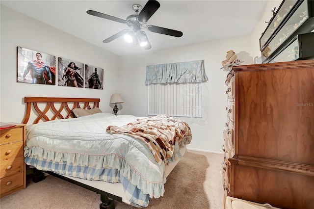 bedroom with ceiling fan and light carpet