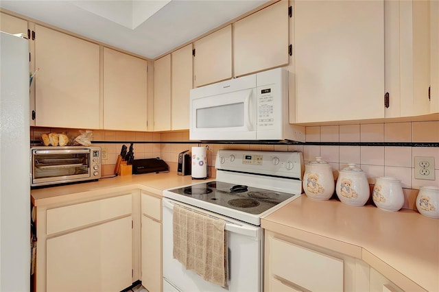 kitchen with decorative backsplash, cream cabinetry, and white appliances