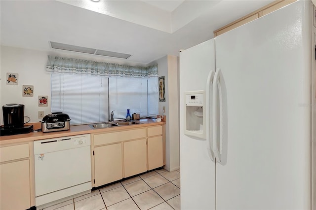 kitchen with light tile patterned flooring, white appliances, and sink