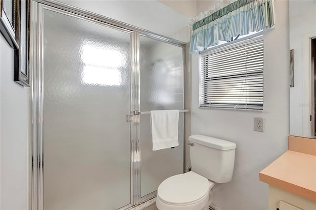 bathroom with vanity, toilet, and walk in shower