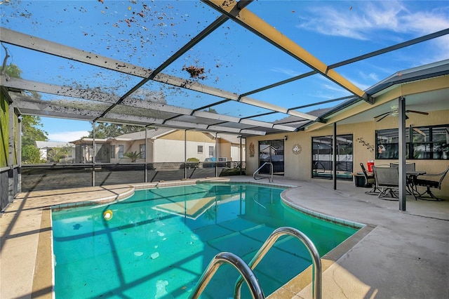 view of pool featuring a patio, ceiling fan, and a lanai