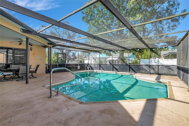 view of pool with ceiling fan, a lanai, and a patio