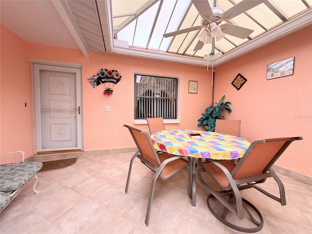 dining space featuring beam ceiling and ceiling fan